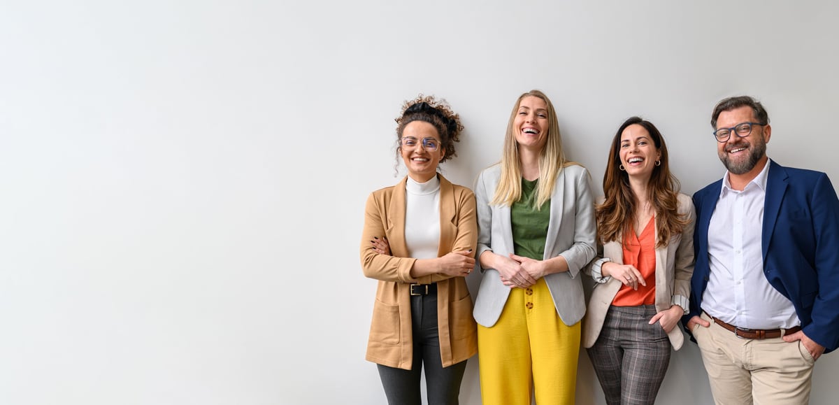 Smiling male and female business professionals standing together